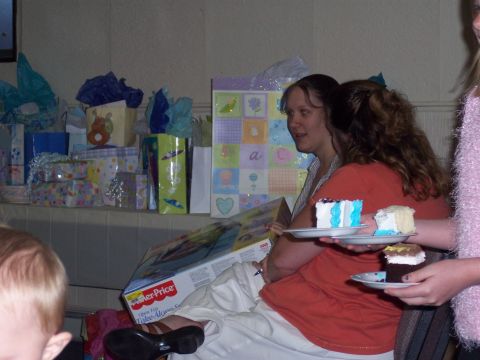1972 Ford Ranchero - A gathering of people at a baby shower, with gifts piled high and slices of cake being served.