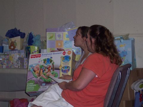 1972 Ford Ranchero - Gifts and two women are seen at a baby shower, with a Fisher-Price Rainforest Bouncer box in the foreground.