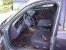 1998 Ford Crown Victoria - The interior of a car is shown, with a focus on the driver's side seat and dashboard.