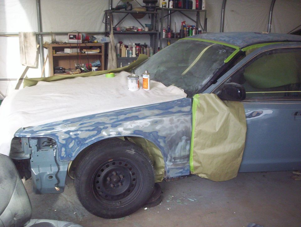 1998 Ford Crown Victoria undergoing bodywork, front fender and hood covered