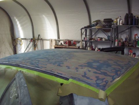 1998 Ford Crown Victoria - Car roof prep work in progress inside a garage. Body filler is visible on the surface.