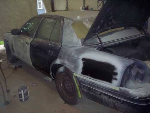 1998 Ford Crown Victoria - This car is in a garage with its hood and trunk open, showing extensive bodywork in progress.