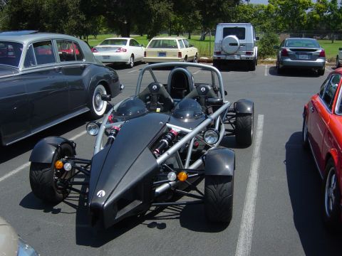 1993 Ford Probe - Ariel Atom sports car parked in a lot next to a classic Rolls-Royce and a red sports car.