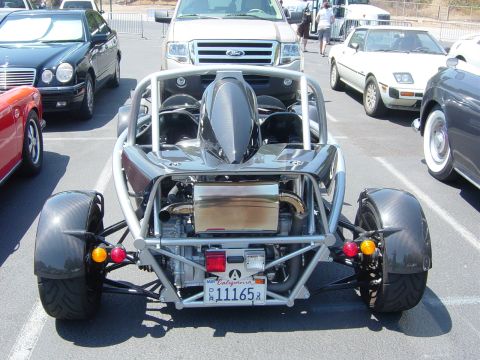 1993 Ford Probe - This rear-engine sports car features an exposed engine and a prominent roll cage, with a California license plate visible.