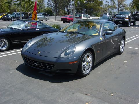 1993 Ford Probe - A gray Ferrari 612 Scaglietti is parked in a lot with other vehicles, showing its front quarter profile.