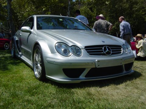 1993 Ford Probe - Silver Mercedes-Benz CLK with wide body kit at an outdoor car show.