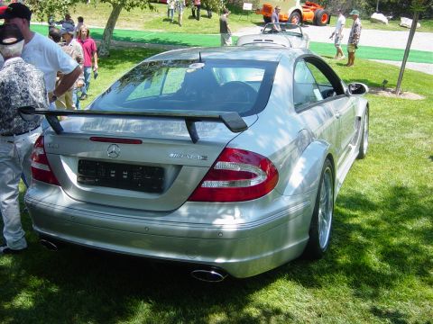 1993 Ford Probe - A silver Mercedes-Benz coupe is displayed outdoors on a grassy lawn with people in the background.