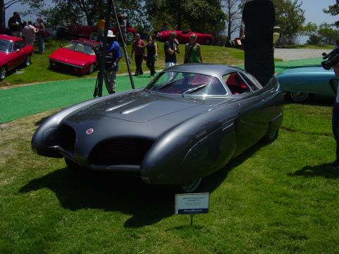1993 Ford Probe - A unique custom concept car is displayed outdoors, with other vehicles and people in the background.