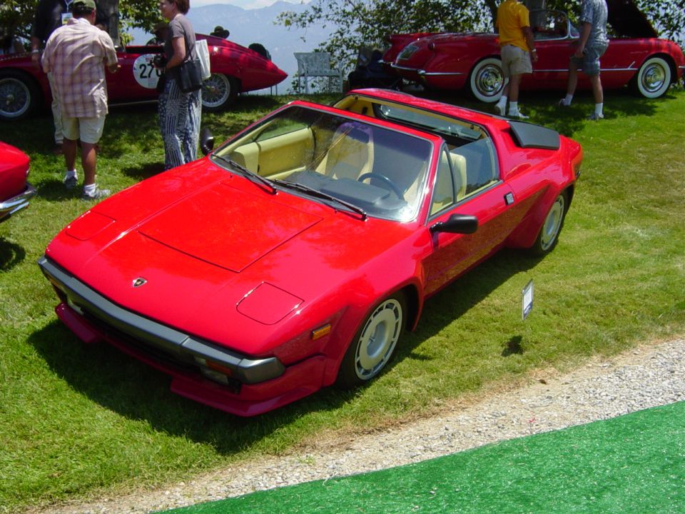 Red sports car with pop-up headlights and targa top