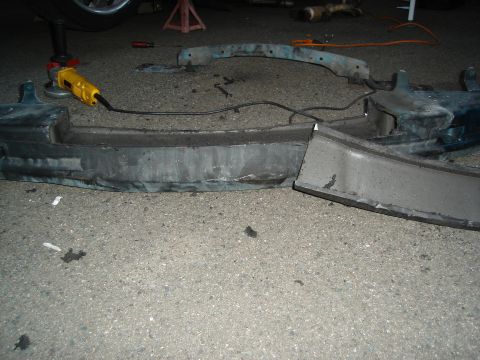 1995 Mazda MX-6 - Angle grinder cutting a car bumper. The registry claims it is a 1995 Mazda MX-6, but this is unconfirmed.