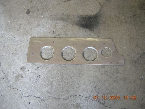1996 Ford Bronco - This aluminum panel features four circular openings, likely for gauges, and appears to be a vehicle part.