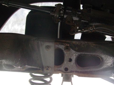1979 Ford Bronco - Underside view of a vehicle's frame and suspension system, showing mechanical components.