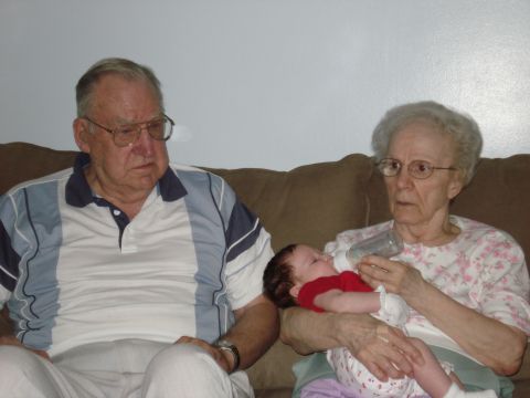 2000 Ford Crown Victoria - A baby is being fed by a woman while an older man watches.
