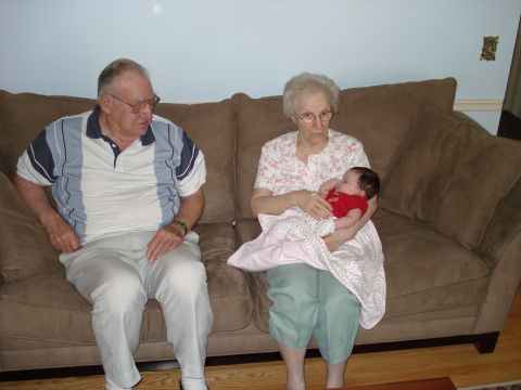 2000 Ford Crown Victoria - A family gathers on a couch, with grandparents holding a baby.