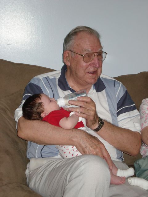 2000 Ford Crown Victoria - Grandfather feeds his grandchild from a bottle.