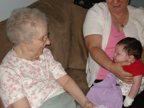 2000 Ford Crown Victoria - Three women, representing different generations, share a moment together on a couch.