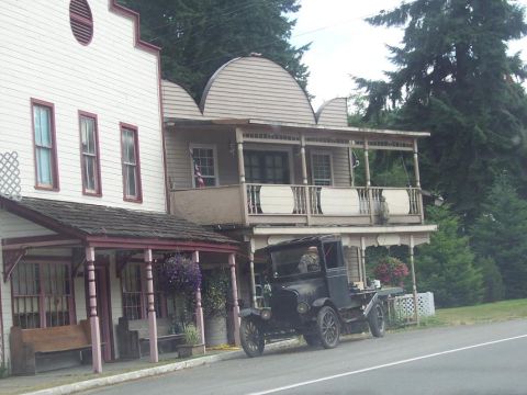 1995 Ford Probe - A vintage truck sits parked on the side of the road next to a pair of old-fashioned buildings.