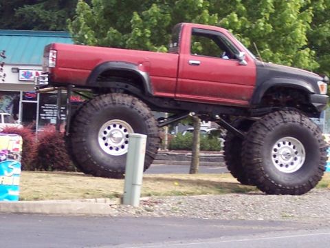 1995 Ford Probe - This heavily modified pickup truck features an extreme lift kit and oversized off-road tires, giving it a formidable stance.