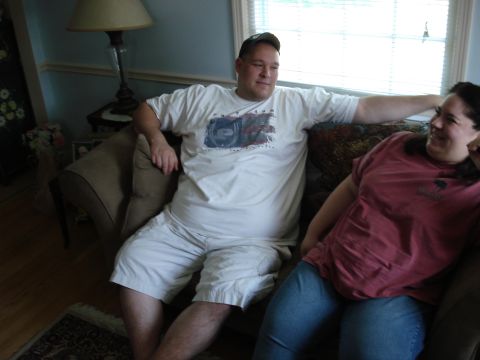 2000 Ford Crown Victoria - A man and woman relax on a couch in a living room setting.