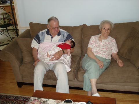2000 Ford Crown Victoria - An elderly couple sits on a couch while the grandfather holds a newborn baby.