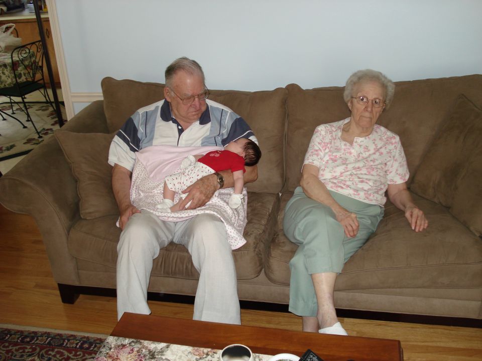 Elderly couple and baby on a couch