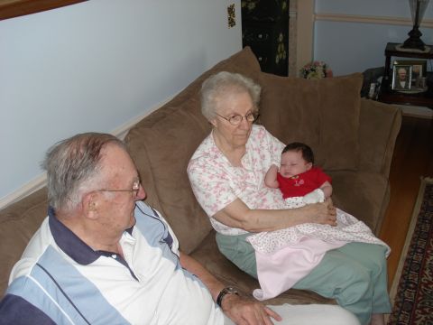 2000 Ford Crown Victoria - An elderly couple sits on a couch with a baby.