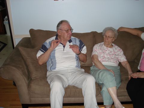 2000 Ford Crown Victoria - An older couple sits on a couch, engaged in conversation.