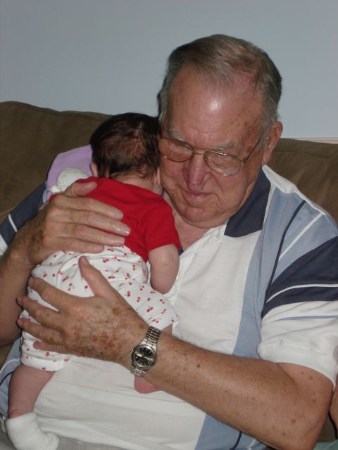 2000 Ford Crown Victoria - A grandfather lovingly cradles his grandchild, sharing a tender moment.