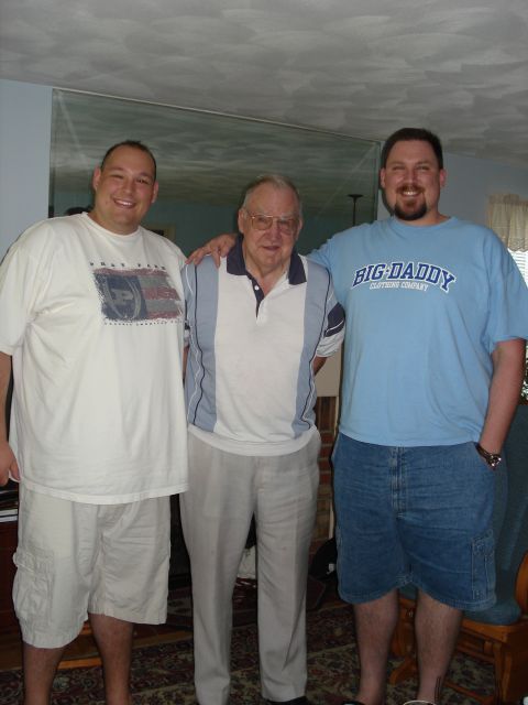 2000 Ford Crown Victoria - Three men pose for a photo indoors, with the man on the right wearing a shirt that reads "BIG DADDY CLOTHING COMPANY".