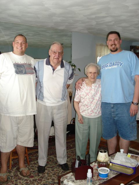 2000 Ford Crown Victoria - A family poses for a photo indoors, with two men, one woman, and an older man standing together.