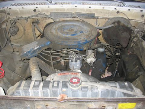 1989 Ford Bronco - Close-up view of a vehicle's engine bay, showing the air cleaner assembly, radiator, and distributor.