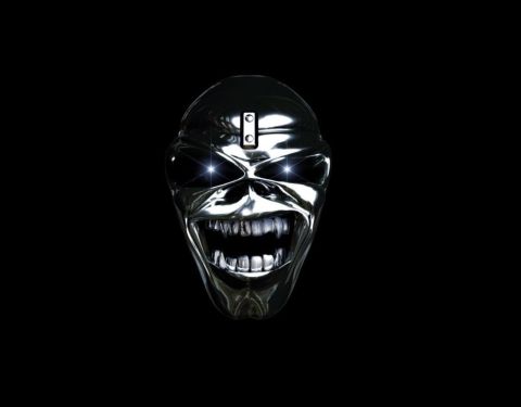 1990 Ford Bronco - A chrome skull mask with a menacing grin and glowing eyes is shown against a black background.