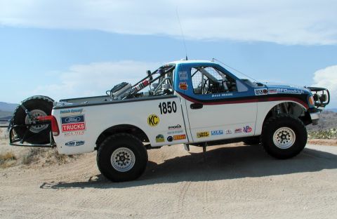 2000 Ford F-150 - This modified Ford F-150 is equipped for off-road racing with a roll cage and large tires.