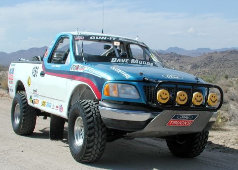 2000 Ford F-150 - This modified Ford F-150 features a custom front bumper with smiley face lights and numerous sponsor decals.