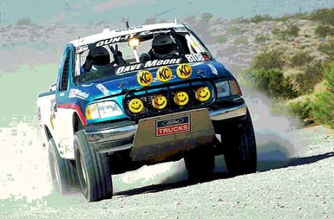 2000 Ford F-150 - A 2000 Ford F-150 truck races off-road, its tires kicking up dust as it navigates a dirt track.