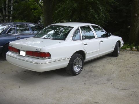 1997 Ford Crown Victoria - White 1997 Ford Crown Victoria parked outdoors next to a blue sedan.