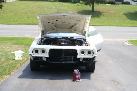 1972 Ford Ranchero - A white 1972 Ford Ranchero is parked outside with its hood open, revealing the engine bay.