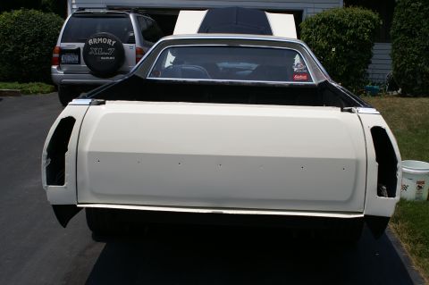 1972 Ford Ranchero - Rear view of a 1972 Ford Ranchero undergoing restoration, parked beside a Suzuki XL7.