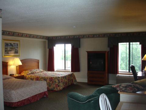 1993 Ford Taurus - Interior view of a hotel room two beds and a seating area with a television.