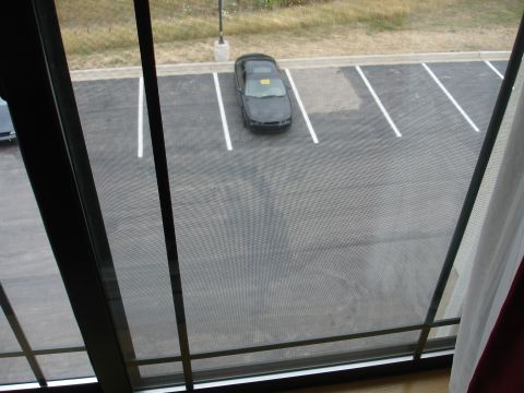 1993 Ford Taurus - A black sedan is parked in a lot, displaying the number 102 on its roof.