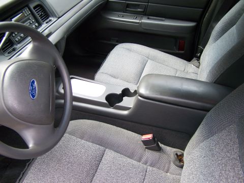 2003 Ford Crown Victoria - Interior view of a 2003 Ford Crown Victoria, showing the steering wheel, dashboard, and front seating area.