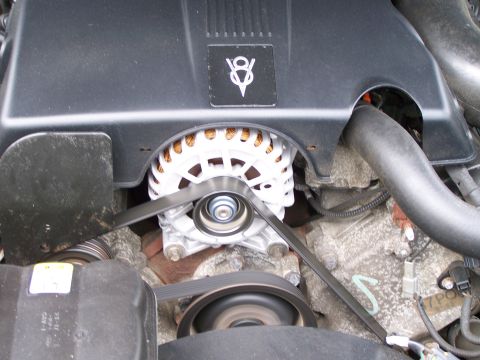 2003 Ford Crown Victoria - Close-up of a V8 engine bay, focusing on the alternator and drive belts.