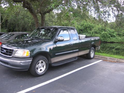 2001 Ford F-150 - Green 2001 Ford F-150 XLT SuperCab pickup truck parked outdoors.