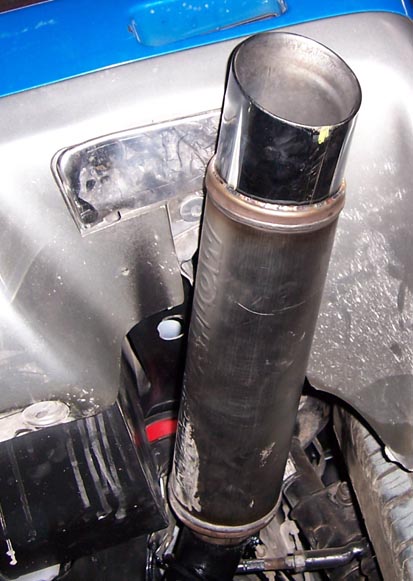 1988 Pontiac Fiero - Exhaust pipe detail with mounting hardware visible.