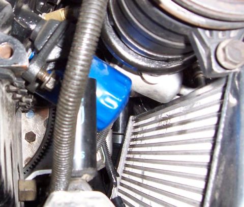 1988 Pontiac Fiero - A close-up view of engine components, including an oil filter and radiator, is visible in this image.