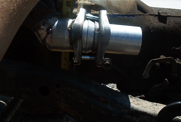 close-up of a newly installed exhaust pipe section with clamps