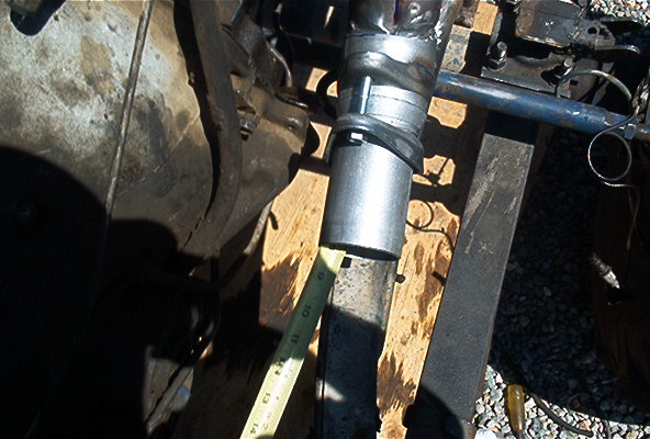 Exhaust pipe section being measured with a yellow tape measure