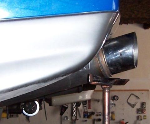 1988 Pontiac Fiero - The underside of a vehicle shows a chrome exhaust tip and part of the rear bodywork.