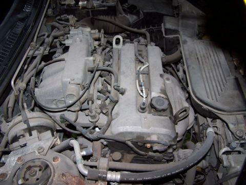2000 Ford Crown Victoria - Close-up view of a car's engine bay, showing various mechanical parts and wiring.