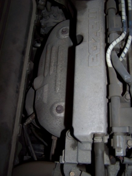 2000 Ford Crown Victoria - Close-up view of an engine component displaying the MAZDA brand name.
